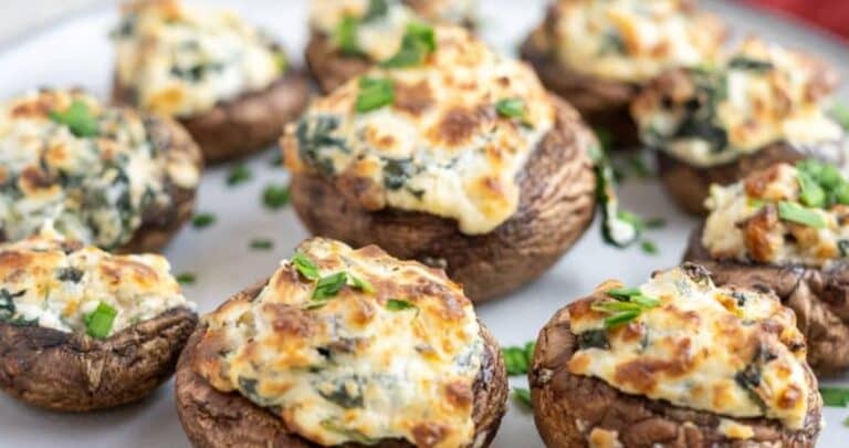 Stuffed mushrooms with spinach and cheese on a plate.