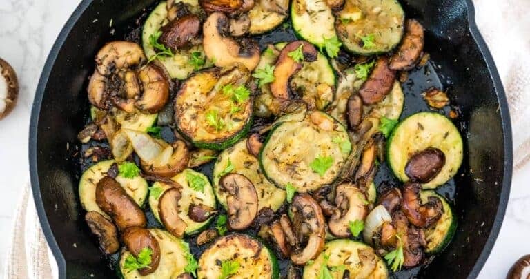 Zucchini and mushrooms in a skillet.
