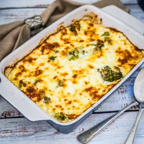 A casserole dish with broccoli and cheese.
